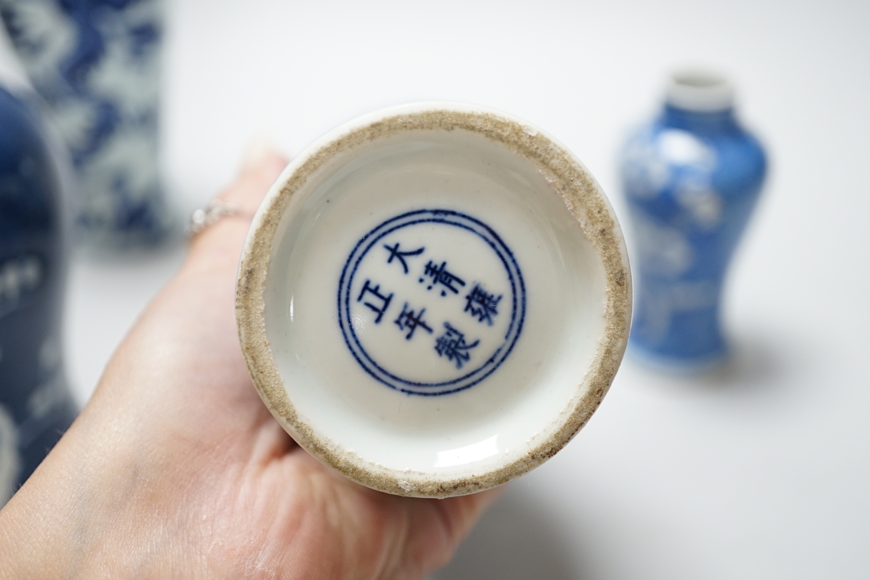 A group of Chinese blue and white ceramics including two prunus flower vases and three bowls, the largest 26cm in diameter